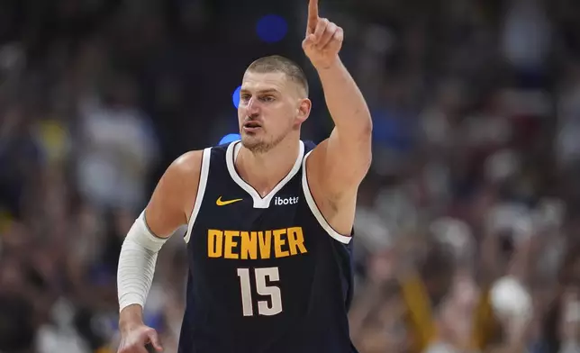 Denver Nuggets center Nikola Jokic gestures to teammates after hitting a basket against the Oklahoma City Thunder in the second half of Game 4 in the Western Conference semifinals of the NBA basketball playoffs Sunday, May 11, 2025, in Denver. (AP Photo/David Zalubowski)