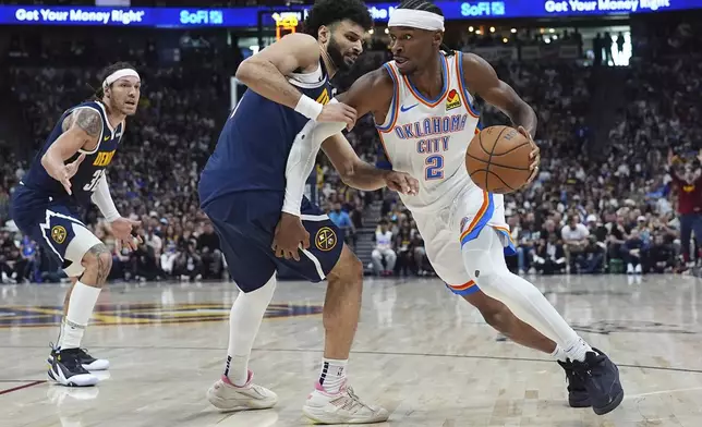 Oklahoma City Thunder guard Shai Gilgeous-Alexander, right, drives past Denver Nuggets guard Jamal Murray, center, and forward Aaron Gordon in the second half of Game 4 in the Western Conference semifinals of the NBA basketball playoffs Sunday, May 11, 2025, in Denver. (AP Photo/David Zalubowski)