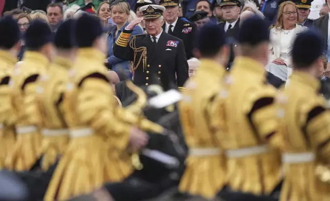 Britain's King Charles III salutes as he watches the V-E Day 80th anniversary parade in London, Monday, May 5, 2025. (AP Photo/Frank Augstein)