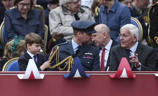 Britain's Prince William and Prince Louis watch the military procession marking the 80th anniversary of V-E Day, in London, Monday, May 5, 2025. (Toby Melville/Pool Photo via AP)