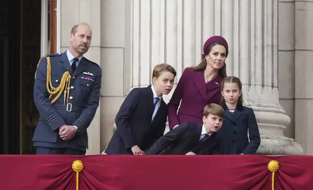 Britain's William, Prince of Wales, left, Prince George, second left, Prince Louis, center, Kate, Princess of Wales, second right, and Princess Charlotte, right, as they appear on the balcony of Buckingham Palace to watch the flypast during the V-E Day 80th anniversary parade in London, Monday, May 5, 2025. (AP Photo/Frank Augstein)