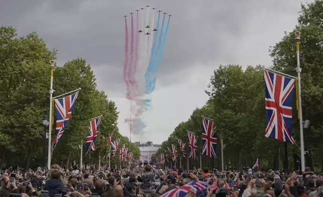 The Red Arrows the Royal Airforce display team, fly over the Mall and Buckingham Palace during the V-E Day 80th anniversary parade in London, Monday, May 5, 2025. (AP Photo/Alberto Pezzali, Pool)