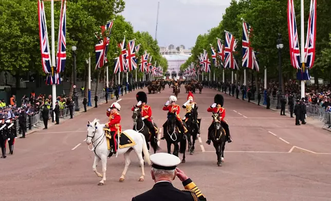 Britain's King Charles III takes the salute from the military procession marking the 80th anniversary of VE Day, in London, Monday, May 5, 2025. (Aaron Chown/Pool Photo via AP)