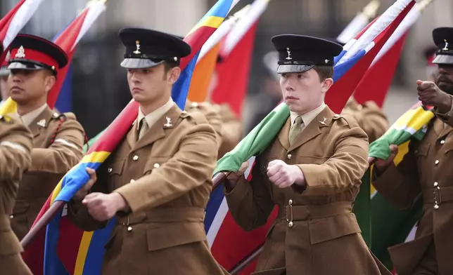 Members of the Colour Party carry flags of the Commonwealth nations , during the VE Day 80th anniversary parade, in London, Monday, May 5, 2025. (James Manning/Pool Photo via AP)