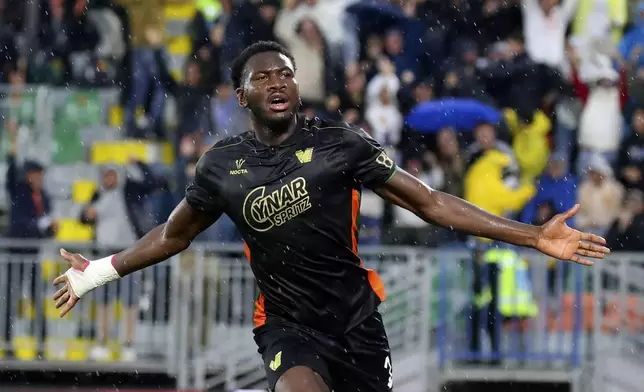 Venezia's Fali Cande celebrates after scoring the opening goal during the Serie A soccer match between Venezia and Fiorentina in Venice, Italy, Monday, May 12, 2025. (Paola Garbuio/LaPresse via AP)