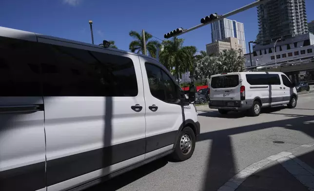 Department of Homeland Security vans leave carrying people detained by U.S. Immigration and Customs Enforcement agents at the Miami Immigration Court in Miami, on Wednesday, May 21, 2025. (AP Photo/Rebecca Blackwell)