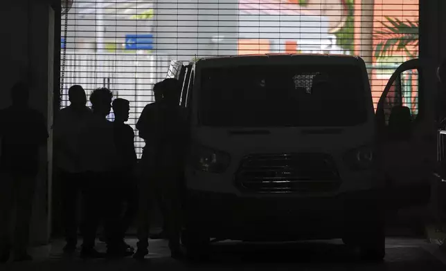 Plainclothes agents from U.S. Immigration and Customs Enforcement load people detained at the Miami Immigration Court into a Department of Homeland Security van in Miami, on Wednesday, May 21, 2025. (AP Photo/Rebecca Blackwell)