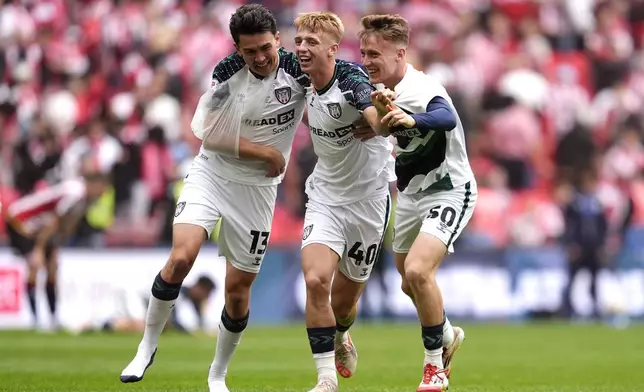 Sunderland's Luke O'Nien, Tom Watson and Harrison Jones celebrate following the Sky Bet Championship play off final between Sheffield United and Sunderland, at Wembley Stadium, London, Saturday May 24, 2025. (Nick Potts/PA via AP)