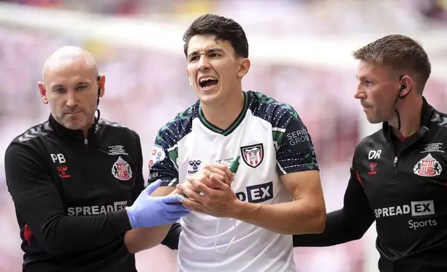 Sunderland's Luke O'Nien receives treatment for an injury during the Sky Bet Championship play off final between Sheffield United and Sunderland, at Wembley Stadium, London, Saturday May 24, 2025. (Ben Whitley/PA via AP)