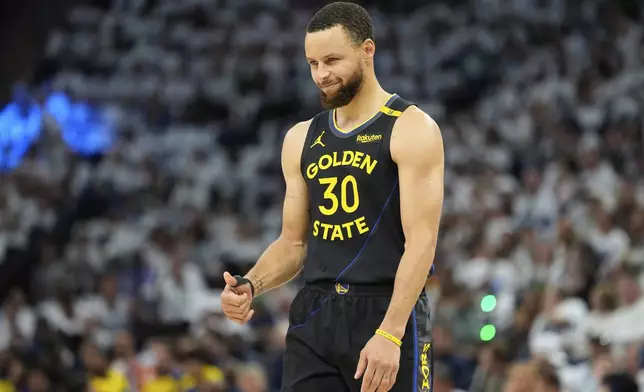 Golden State Warriors guard Stephen Curry (30) gestures during the first half of Game 1 of an NBA basketball second-round playoff series against the Minnesota Timberwolves, Tuesday, May 6, 2025, in Minneapolis. (AP Photo/Abbie Parr)