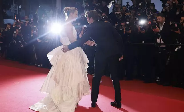 Jennifer Lawrence, left, and Robert Pattinson pose for photographers upon arrival at the premiere of the film 'Die, My Love' at the 78th international film festival, Cannes, southern France, Saturday, May 17, 2025. (Photo by Joel C Ryan/Invision/AP)