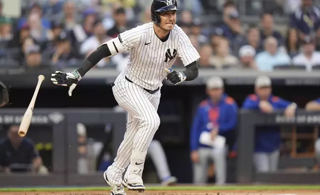 New York Yankees' Cody Bellinger follows through on a two-run double during the first inning of a baseball game against the New York Mets Sunday, May 18, 2025, in New York. (AP Photo/Frank Franklin II)