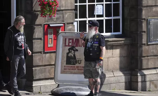 Motorhead fans gather to commemorate Lemmy Kilmister the Motorhead frontman in Burslem, Stoke on Trent, England, Friday, May 9, 2025. The musician, once described as having 'one of the most recognizable voices in rock', was born in Burslem and a statue has been crafted by acclaimed local sculptor and lifelong Motorhead fan Andy Edwards. (AP Photo/Kirsty Wigglesworth)