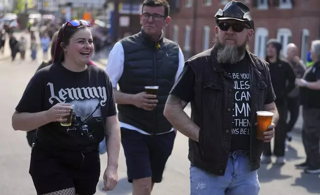 Motorhead fans gather to commemorate Lemmy Kilmister the Motorhead frontman in Burslem, Stoke on Trent, England, Friday, May 9, 2025. The musician, once described as having 'one of the most recognizable voices in rock', was born in Burslem and a statue has been crafted by acclaimed local sculptor and lifelong Motorhead fan Andy Edwards. (AP Photo/Kirsty Wigglesworth)