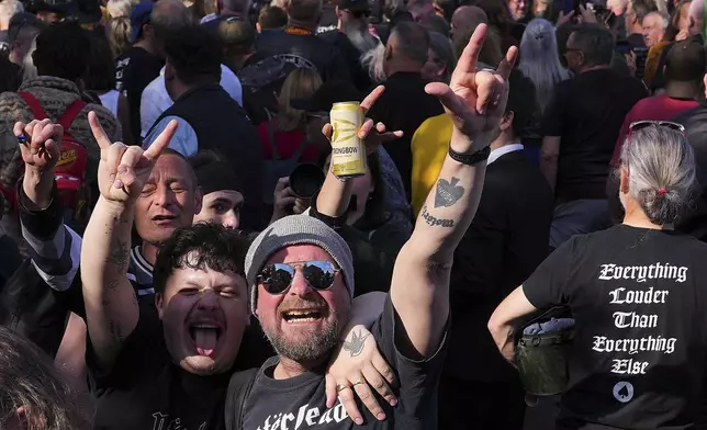 Motorhead fans gather to commemorate Lemmy Kilmister the Motorhead frontman in Burslem, Stoke on Trent, England, Friday, May 9, 2025. The musician, once described as having 'one of the most recognizable voices in rock', was born in Burslem and a statue has been crafted by acclaimed local sculptor and lifelong Motorhead fan Andy Edwards. (AP Photo/Kirsty Wigglesworth)