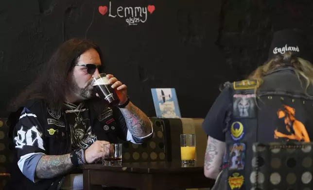 Motorhead fans meet in a pub to commemorate Lemmy Kilmister the Motorhead frontman in Burslem, Stoke on Trent, England, Friday, May 9, 2025. The musician, once described as having 'one of the most recognizable voices in rock', was born in Burslem and a statue has been crafted by acclaimed local sculptor and lifelong Motorhead fan Andy Edwards. (AP Photo/Kirsty Wigglesworth)