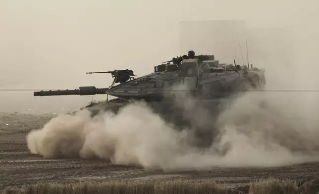 An Israeli tank moves in a staging area in southern Israel, near the border with Gaza, Friday, May 16, 2025. (AP Photo/Maya Alleruzzo)