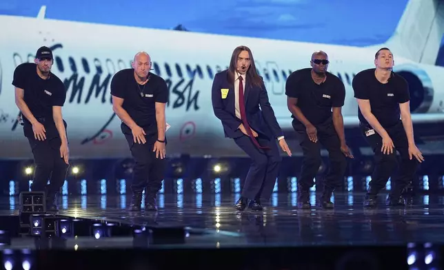 Tommy Cash from Estonia performs the song "Espresso Macchiato" during the first semi-final of the 69th Eurovision Song Contest, in Basel, Switzerland, Tuesday, May 13, 2025. (AP Photo/Martin Meissner)