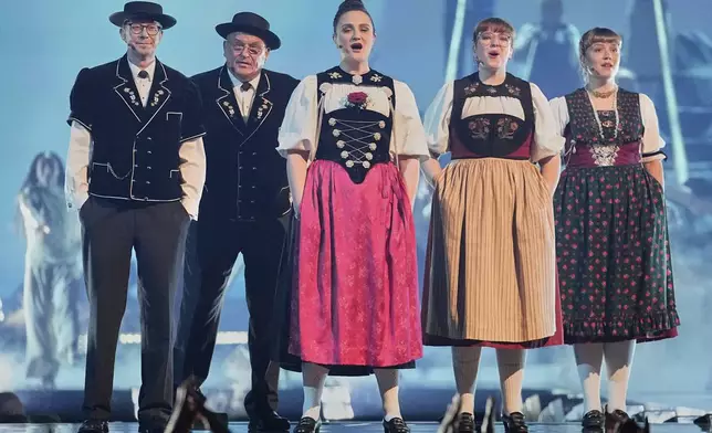 Traditional Swiss singers open the show ahead of the start of the first semi-final of the 69th Eurovision Song Contest, in Basel, Switzerland, Tuesday, May 13, 2025. (AP Photo/Martin Meissner)
