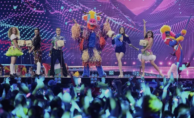 Dances in costume perform during an interval during the first semi-final of the 69th Eurovision Song Contest, in Basel, Switzerland, Tuesday, May 13, 2025. (AP Photo/Martin Meissner)