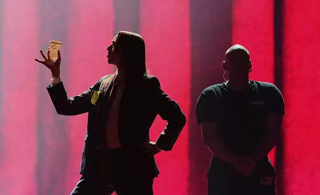 Tommy Cash from Estonia performs the song "Espresso Macchiato" during the first semi-final of the 69th Eurovision Song Contest, in Basel, Switzerland, Tuesday, May 13, 2025. (AP Photo/Martin Meissner)