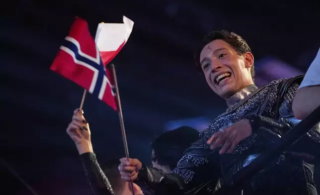 Kyle Alessandro from Norway who performed the song "Lighter" celebrates after progressing through first semi-final to the final of the 69th Eurovision Song Contest, in Basel, Switzerland, Tuesday, May 13, 2025. (AP Photo/Martin Meissner)
