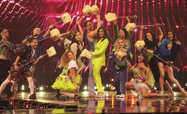 Hosts Hazel Brugger, centre right and Sandra Studer, centre left, on stage during the first semi-final of the 69th Eurovision Song Contest, in Basel, Switzerland, Tuesday, May 13, 2025. (AP Photo/Martin Meissner)