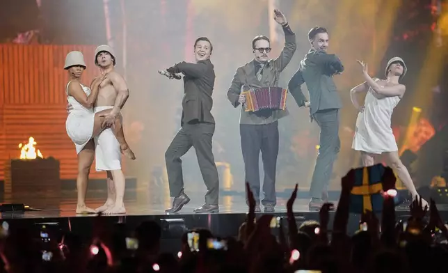 KAJ from Sweden performs the song "Bara Bada Bastu" during the first semi-final of the 69th Eurovision Song Contest, in Basel, Switzerland, Tuesday, May 13, 2025. (AP Photo/Martin Meissner)