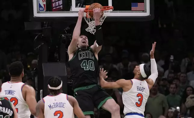 Boston Celtics center Luke Kornet (40) dunks against New York Knicks guard Josh Hart (3) during the second half of Game 5 of an NBA basketball second-round playoff series, Wednesday, May 14, 2025, in Boston. (AP Photo/Charles Krupa)