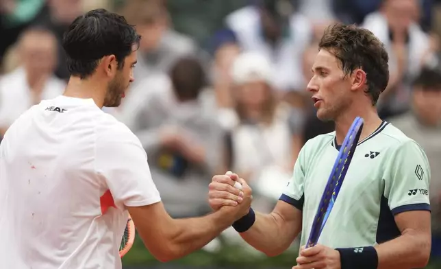 Portugal's Nuno Borges, left, is congratulated by Norway's Casper Ruud after their second round match of the French Tennis Open, at the Roland-Garros stadium, in Paris, Wednesday, May 28, 2025. (AP Photo/Lindsey Wasson)