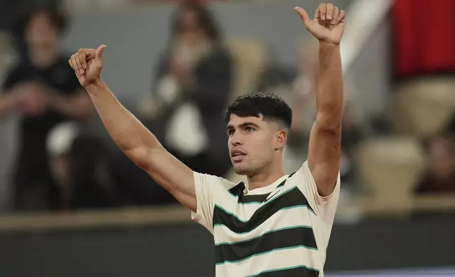 Spain's Carlos Alcaraz celebrates beating Hungary's Fabian Maroszan after their second round match of the French Tennis Open, at the Roland-Garros stadium, in Paris, Wednesday, May 28, 2025. (AP Photo/Christophe Ena)