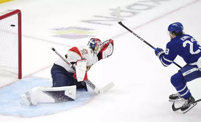 Toronto Maple Leafs forward Matthew Knies (23) scores against Florida Panthers goaltender Sergei Bobrovsky, left, during during the third period of Game 1 in an NHL hockey second-round playoff series in Toronto, Monday, May 5, 2025. (Frank Gunn/The Canadian Press via AP)