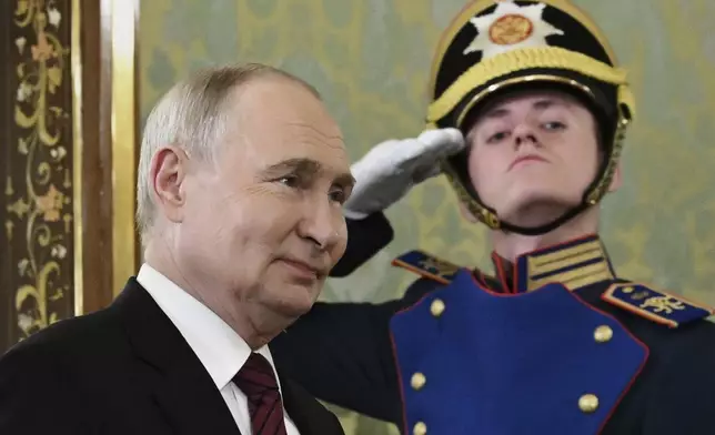 Russian President Vladimir Putin enters a hall to meet South Ossetian President Alan Gagloyev in the Grand Palace at the Kremlin in Moscow, Russia, on Saturday, May 10, 2025, during celebrations of the 80th anniversary of the Soviet Union's victory over Nazi Germany during the World War II. (Sergei Bobylev/RIA Novosti via AP)