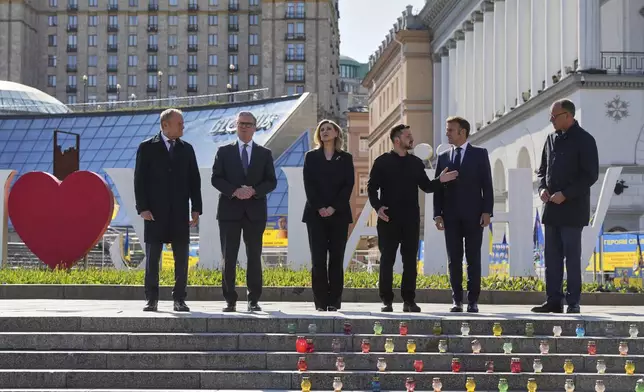 From left, Polish Prime Minister Donald Tusk, U.K. Prime Minister Keir Starmer, Ukraine's First Lady Olena Zelenska Olena Zelenska,Ukrainian President Volodymyr Zelenskyy, French President Emmanuel Macron and German Chancellor Friedrich Merz stand at the memorial of fallen Ukrainian soldiers at independence square in Kyiv, Ukraine, on Saturday, May 10, 2025. (AP Photo/Evgeniy Maloletka)