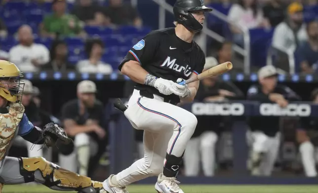 Miami Marlins' Kyle Stowers hits a single to center field during the sixth inning of a baseball game against the Tampa Bay Rays, Friday, May 16, 2025, in Miami. (AP Photo/Marta Lavandier)