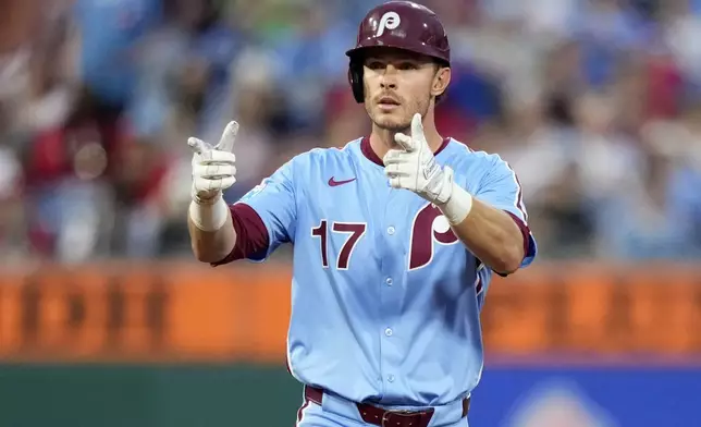 Philadelphia Phillies' Max Kepler reacts after hitting a double against Washington Nationals pitcher Brad Lord during the fifth inning of a baseball game, Thursday, May 1, 2025, in Philadelphia. (AP Photo/Matt Slocum)