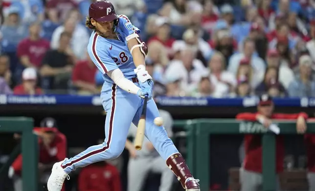 Philadelphia Phillies' Alec Bohm hits a run-scoring single against Washington Nationals pitcher Brad Lord during the fifth inning of a baseball game, Thursday, May 1, 2025, in Philadelphia. (AP Photo/Matt Slocum)