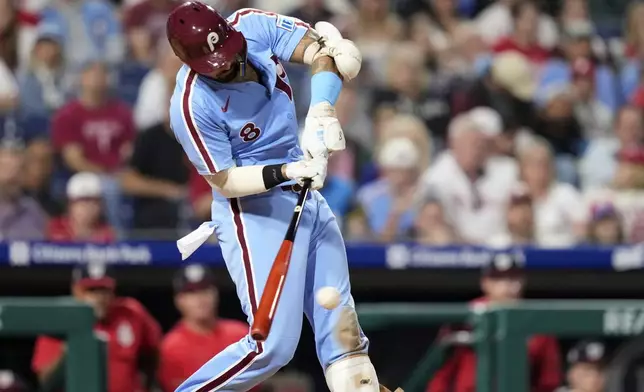 Philadelphia Phillies' Nick Castellanos hits a run-scoring single against Washington Nationals pitcher Jose A. Ferrer during the sixth inning of a baseball game, Thursday, May 1, 2025, in Philadelphia. (AP Photo/Matt Slocum)