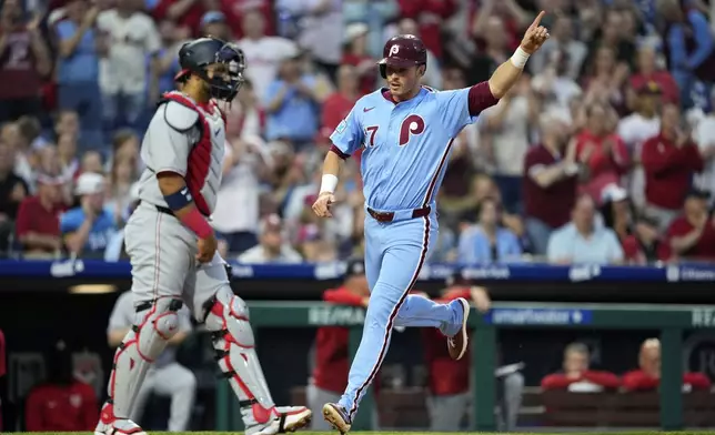Philadelphia Phillies' Max Kepler, right, reacts as he scores past Washington Nationals catcher Keibert Ruiz on a single by Alec Bohm during the fifth inning of a baseball game, Thursday, May 1, 2025, in Philadelphia. (AP Photo/Matt Slocum)