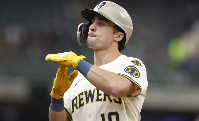 Milwaukee Brewers' Sal Frelick reacts after his RBI single against the Minnesota Twins during the third inning of a baseball game, Sunday, May 18, 2025, in Milwaukee. (AP Photo/Jeffrey Phelps)