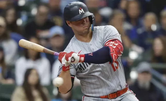 Minnesota Twins' Ty France is hit by a pitch during the first inning of a baseball game against the Milwaukee Brewers, Sunday, May 18, 2025, in Milwaukee. (AP Photo/Jeffrey Phelps)