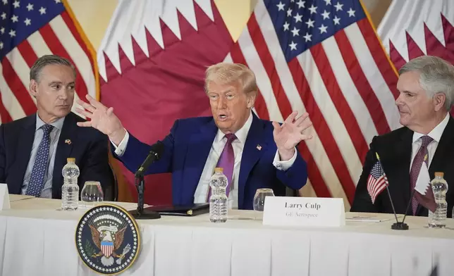 President Donald Trump speaks, seated between Kelly Ortberg President and CEO of Boeing, left, and Larry Culp, CEo of GE Aerospace during a business roundtable, Thursday, May 15, 2025, in Doha, Qatar. (AP Photo/Alex Brandon)