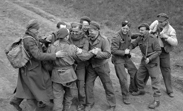 FILE - Recently released British prisoners of war meet up with a parachute recce party while marching towards Allied lines, in Germany May 4, 1945. German authorities have recently released 8,000 British prisoners of war. (AP Photo/Eddie Worth, File)