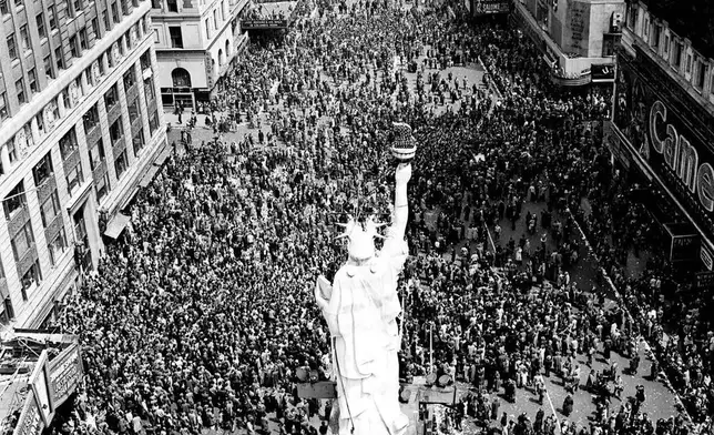 People crowd Times Square at 42nd Street in New York City on May 8, 1945, as the V-E Day celebration continues into the night. (AP Photo/Matty Zimmerman, File)