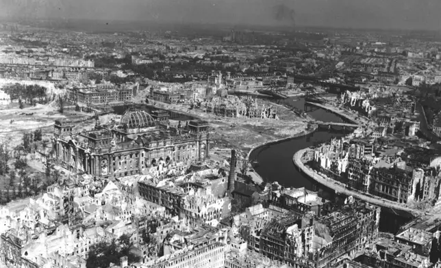 FILE - A view taken from a Cub artillery observation plane on July 10, 1945, shows vast areas of destruction in Berlin, after repeated Anglo-American air raids on the German capital. Seen on the left, center, is the heavily damaged building of the German Reichstag with its distinct cupola, in the background center are the remains of Lehrter Bahnhof, one of the city's train stations. (AP Photo, File)