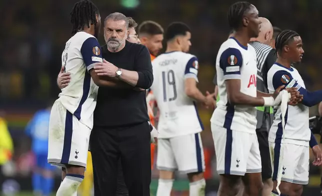 Tottenham's head coach Ange Postecoglou, left, celebrates with players after the Europa League semifinal first leg soccer match between Tottenham Hotspur and Bodo/Glimt at the White Hart Lane stadium in London, Thursday, May 1, 2025. (AP Photo/Kirsty Wigglesworth)