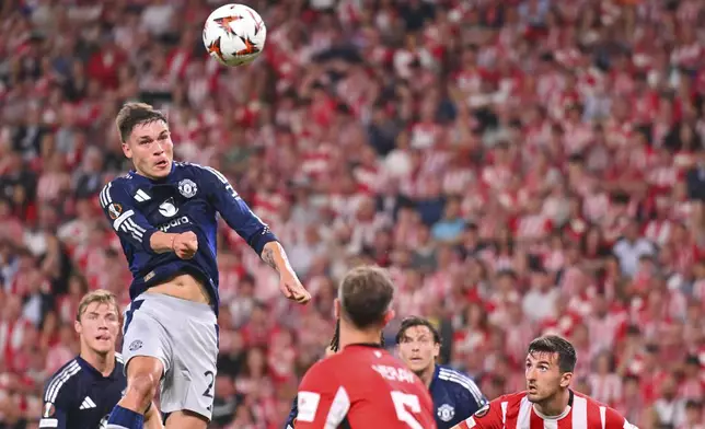Manchester United's Manuel Ugarte heads the ball during the Europa League semifinal first leg soccer match between Athletic Bilbao and Manchester United at the San Mames stadium in Bilbao, Spain, Thursday, May 1, 2025. (AP Photo/Miguel Oses)