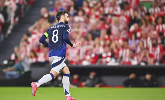 Manchester United's Bruno Fernandes celebrates after scoring his side's second goal during the Europa League semifinal first leg soccer match between Athletic Bilbao and Manchester United at the San Mames stadium in Bilbao, Spain, Thursday, May 1, 2025. (AP Photo/Miguel Oses)