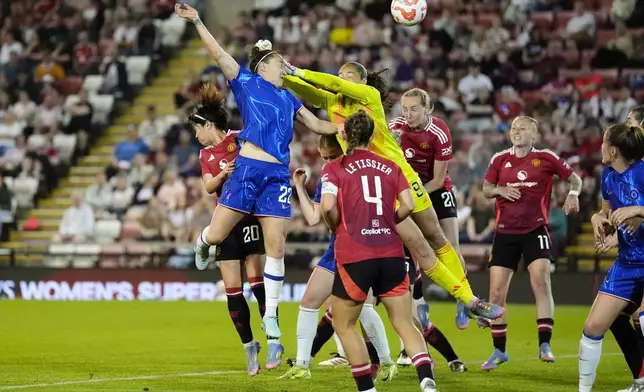 Chelsea's Lucy Bronze (22) scores their side's first goal of the game during the English Women's Super League soccer match between Manchester United and Chelsea at Leigh Sports Village in Manchester, England, Wednesday April 30, 2025. (Nick Potts/PA via AP)