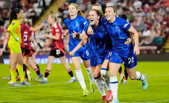 Chelsea's Lucy Bronze (22) celebrates with teammates after scoring their side's first goal of the game during the English Women's Super League soccer match between Manchester United and Chelsea at Leigh Sports Village in Manchester, England, Wednesday April 30, 2025. (Nick Potts/PA via AP)